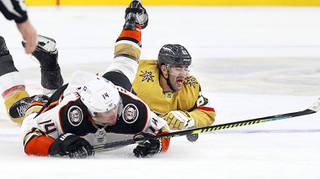 Anaheim Ducks center Adam Henrique (14) and Vegas Golden Knights left wing Max Pacioretty (67) fall to the ice during the third period of an NHL hockey game Saturday, Jan. 16, 2021, in Las Vegas.