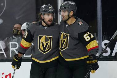 Vegas Golden Knights center Chandler Stephenson, left, embraces left wing Max Pacioretty (67) after Pacioretty scored against the Arizona Coyotes during the second period of an NHL hockey game Monday, Jan. 18, 2021, in Las Vegas. 