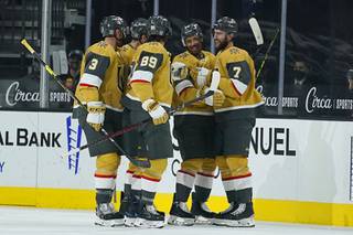 Vegas Golden Knights players celebrate after defenseman Alex Pietrangelo (7) scored against the Arizona Coyotes during the first period of an NHL hockey game Wednesday, Jan. 20, 2021, in Las Vegas.