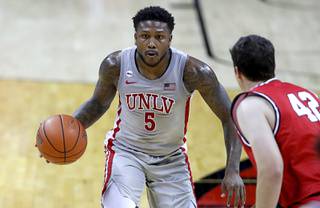 UNLV Rebels guard David Jenkins Jr. (5) is guarded by Benedictine Mesa Redhawks Nick Sessions (42) during a game at the Thomas & Mack Center Thursday Jan. 21, 2021.
