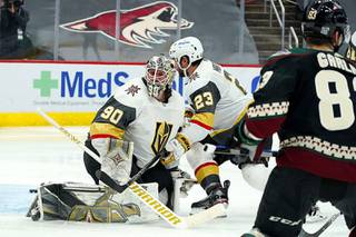 Arizona Coyotes right wing Conor Garland (83) scores a goal against Vegas Golden Knights goaltender Robin Lehner (90) as Golden Knights defenseman Alec Martinez (23) looks for the puck during the third period of an NHL hockey game Friday, Jan. 22, 2021, in Glendale, Ariz.