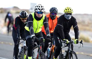 A group of cyclists ride on Highway 159 toward the Red Rock Canyon National Conservation Area Saturday, Jan. 23, 2021.