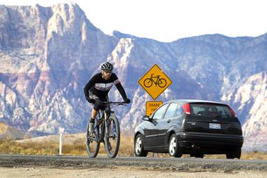 A cyclist heads toward Las Vegas on Highway 159 near the Red Rock Canyon National Conservation Area Saturday, Jan. 23, 2021.