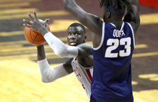 UNLV Rebels forward Cheikh Mbacke Diong (34) looks for a shot around Utah State Aggies center Neemias Queta (23) during a game at the Thomas & Mack Center Wednesday, Jan. 27, 2021.