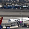 A Volaris Airlines passenger jet taxis to a gate after landing at Las Vegas airport, Thursday, Jan. 28, 2021.
