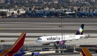 A Volaris Airlines passenger jet taxis to a gate after landing at Las Vegas airport, Thursday, Jan. 28, 2021.