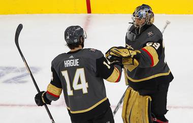 Vegas Golden Knights defenseman Nicolas Hague (14) celebrates with goaltender Marc-Andre Fleury (29) after defeating the Los Angeles Kings, 5-2, at T-Mobile Arena Friday, Feb. 5, 2021.