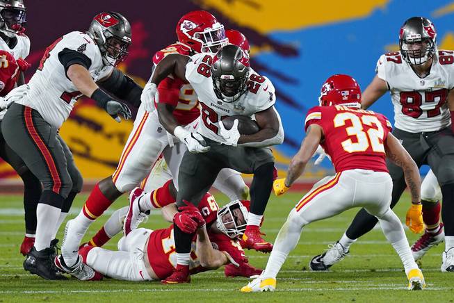 Kansas City Chiefs free safety Daniel Sorensen grabs the leg of Tampa Bay Buccaneers running back Leonard Fournette during the first half of the NFL Super Bowl 55 football game Sunday, Feb. 7, 2021, in Tampa, Fla. (AP Photo/Mark Humphrey)

