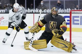 Los Angeles Kings right wing Dustin Brown (23) scores against Vegas Golden Knights goaltender Marc-Andre Fleury (29) during the third period of an NHL hockey game Friday, Feb. 5, 2021, in Las Vegas. (AP Photo/John Locher)
