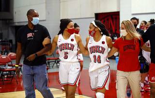 UNLV Lady Rebels guard Bailey Thomas (14) is accompanied by her father Derek, her sister Jade (5), and her mother Julie during a Senior Day ceremony at Cox Pavilion Wednesday, Feb. 10, 2021.