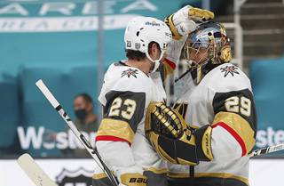 Vegas Golden Knights defenseman Alec Martinez (23) celebrates with Vegas Golden Knights goaltender Marc-Andre Fleury (29) after a win over the San Jose Sharks in an NHL hockey game in San Jose, Calif., Saturday, Feb. 13, 2021.