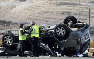 Nevada Highway Patrol investigators work at the scene of a fatal crash at Las Vegas Boulevard South and St. Rose Parkway in Henderson Saturday, Feb. 13, 2021.