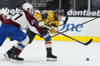 Vegas Golden Knights center William Karlsson (71) attempts a shot around Colorado Avalanche defenseman Ryan Graves (27) during the second period of an NHL hockey game Sunday, Feb. 14, 2021, in Las Vegas.