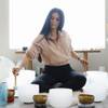Reiki Master Monej Cruz, owner of Potent Habit, a health and beauty business, uses singing bowls in her studio, Wednesday, Feb. 10, 2021.