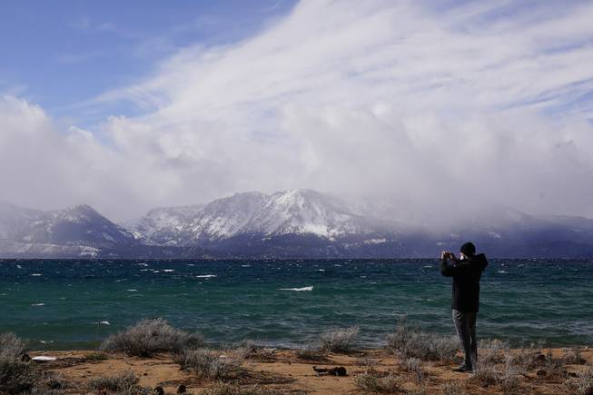 A person takes in the view of Lake Tahoe along the shore of the Edgewood Tahoe Resort, Friday, Feb. 19, 2021, that will host two NHL Hockey games, this weekend at Stateline, Nev. The Colorado Avalanche will play the Vegas Golden Knights Saturday and the Philadelphia Flyers will face off against the Boston Bruins Sunday. 