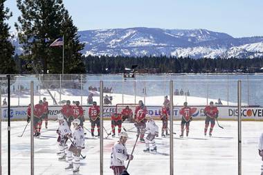 Members of the Colorado Avalanche, in white, and the Vegas Golden Knights, red, prepare to face off to start the first period of the Outdoor Lake Tahoe NHL hockey game in Stateline, Nev., Saturday, Feb. 20, 2021.