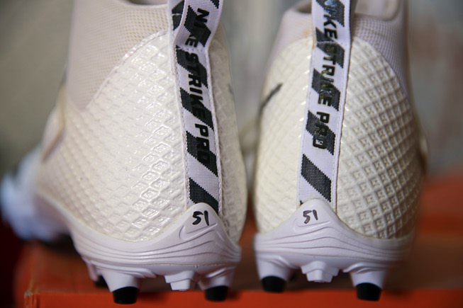 New Nike cleats with the handwritten number 51, donated by ...