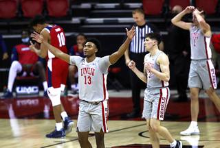 UNLV Rebels Bryce Hamilton (13), Caleb Grill (3) and Moses Wood (1) celebrate after beating the Fresno State Bulldogs, 68-67, at the Thomas & Mack Center Friday, Feb. 26, 2021. 