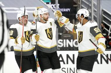 Vegas Golden Knights defenseman Alex Pietrangelo, center, celebrates his goal with left wing William Carrier, left, and right wing Keegan Kolesar during the first period of an NHL hockey game against the Anaheim Ducks Saturday, Feb. 27, 2021, in Anaheim, Calif. (AP Photo/Mark J. Terrill)