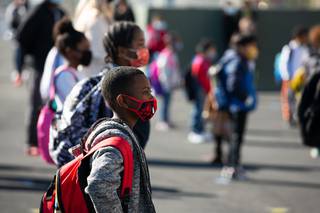 Students arrive at Rex Bell Elementary School on the first day of in-person school, Monday March 1, 2021.