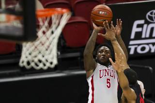 UNLV Rebels guard David Jenkins Jr. (5) shoots for a three pointer as San Diego State Aztecs forward Keshad Johnson (0) tries to block him during a game at Thomas & Mack Center, Wednesday, March 3, 2021.