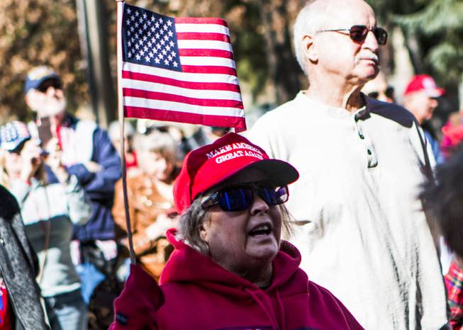 A woman listens to the Nevada GOP in front of the Nevada Capitol where the party delivered what they described as 120,000 "election integrity violation reports" that allege widespread voter fraud in the 2020 election Thursday, March 4, 2021.