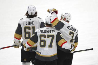 Golden Knights right wing Mark Stone (61), left wing Max Pacioretty (67) and defenseman Alex Pietrangelo (7) celebrate the team’s overtime win against the San Jose Sharks in an NHL hockey game in San Jose, Calif., Friday, March 5, 2021. 