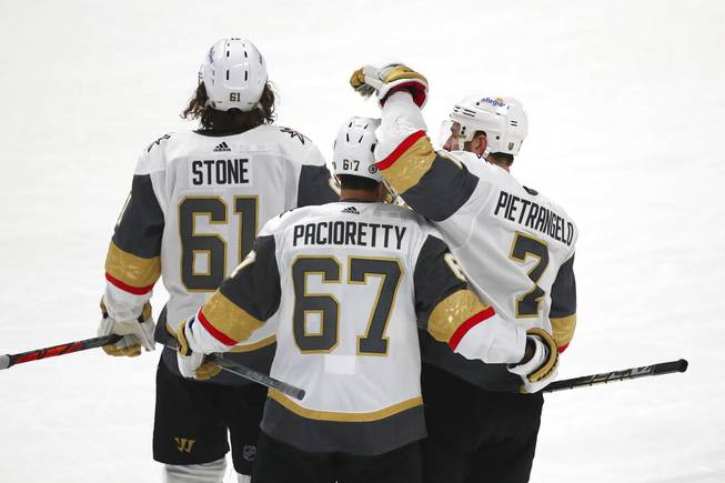 Golden Knights right wing Mark Stone (61), left wing Max Pacioretty (67) and defenseman Alex Pietrangelo (7) celebrate the team's overtime win against the San Jose Sharks in an NHL hockey game in San Jose, Calif., Friday, March 5, 2021. 