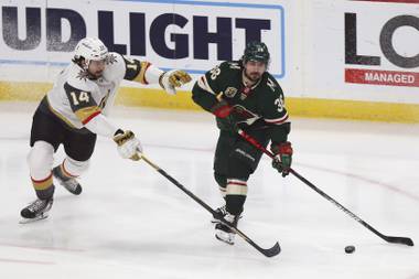 Minnesota Wild’s Mats Zuccarello (36) handles the puck against Vegas Golden Knights’ Nicolas Hague (14) in the first period of an NHL hockey game, Monday, March 8, 2021, in St. Paul, Minn. (AP Photo/Stacy Bengs)