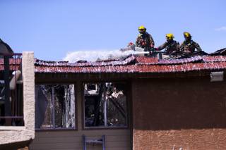 Fire fighters work the scene of a fire that destroyed a building at an apartment complex on W Twain Ave and Arville St, Tuesday, March 9, 2021.
