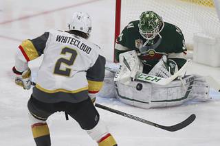 Minnesota Wild's goalie Kaapo Kahkonen (34) stops the puck shot by Vegas Golden Knights' Zach Whitecloud (2) during the first period of an NHL hockey game Wednesday, March 10, 2021, in St. Paul, Minn.