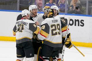 Vegas Golden Knights Jonathan Marchessault (81), William Karlsson, second from left, goaltender Marc-Andre Fleury (29) and Chandler Stephenson celebrate after defeating the St. Louis Blues in overtime of an NHL hockey game Friday, March 12, 2021, in St. Louis.