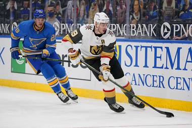 Vegas Golden Knights’ Reilly Smith (19) controls the puck as St. Louis Blues’ Mackenzie MacEachern (28) defends during the second period of an NHL hockey game Saturday, March 13, 2021, in St. Louis.