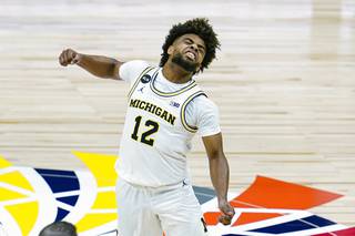 Michigan guard Mike Smith (12) celebrates as Michigan took the lead at halftime in an NCAA college basketball game against Maryland at the Big Ten Conference tournament in Indianapolis, Friday, March 12, 2021. 

