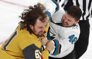 Vegas Golden Knights right wing Mark Stone (61) takes a punch from San Jose Sharks center Tomas Hertl (48) in the third period at T-Mobile Arena Wednesday, March 17, 2021.