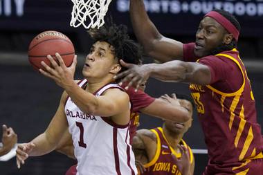 Oklahoma forward Jalen Hill (1) gets past Iowa State forward Solomon Young (33) during the first half of an NCAA college basketball game in the first round of the Big 12 men’s tournament in Kansas City, Mo., Wednesday, March 10, 2021. 