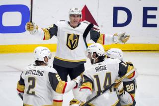 Vegas Golden Knights left wing Tomas Nosek, top, celebrates after assisting on a goal from William Carrier, right, during the third period of the team's NHL hockey game against the Los Angeles Kings on Friday, March 19, 2021, in Los Angeles.