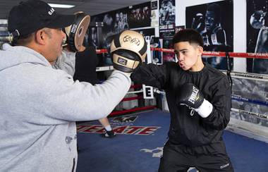 Kaipo Gallegos, 15, works on his timing with his father and trainer Jayson Gallegos at the Las Vegas Fight Club gym Friday, March 19, 2021. Gallegos will compete in the USA Boxing National Championships, March 25 - April 3, for a chance to make the USA Olympic boxing team.