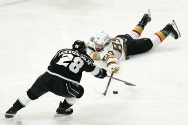 Los Angeles Kings center Jaret Anderson-Dolan, left, and Vegas Golden Knights right wing Alex Tuch go after the puck during the first period of an NHL hockey game Sunday, March 21, 2021, in Los Angeles. (AP Photo/Mark J. Terrill)