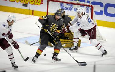 Colorado Avalanche right wing Mikko Rantanen (96) chips the puck past Vegas Golden Knights defenseman Alec Martinez (23) to Avalanche left wing Gabriel Landeskog (92) who scored on the play in the second period in Denver, Thursday, March 25, 2021. 