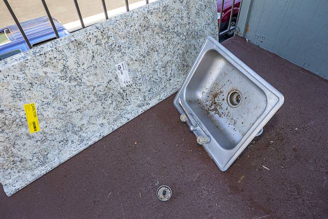 An old kitchen sink is shown next to a new kitchen countertop at the SHARE Village Las Vegas 2, an affordable housing complex for veterans, families and those with special needs, near downtown Las Vegas Saturday, March 27, 2021. Thirty-five carpenters from Carpenters Union Local 1977 rehabbed kitchens and bathrooms in 10 units as part of their annual volunteer work at the complex.