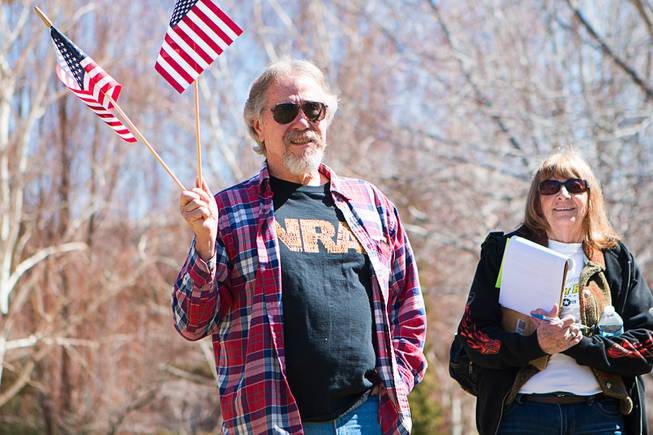 People attend a pro-gun rally at the Nevada State Capitol complex in Carson City Saturday, March 27, 2021. The protesters are opposed gun control legislation, including AB 286, which would ban ghost guns, or firearms without serial numbers, which are often built at home. About 100 people attended the rally.