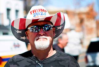 A man listens to speakers during a pro-gun rally at the Nevada State Capitol complex in Carson City Saturday, March 27, 2021. The protesters are opposed gun control legislation, including AB 286, which would ban ghost guns, or firearms without serial numbers, which are often built at home. About 100 people attended the rally.