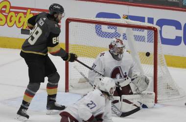 Vegas Golden Knights right wing Alex Tuch (89) watches Golden Knights defenseman Alec Martinez’ goal against Colorado Avalanche goaltender Philipp Grubauer (31) during the first period of an NHL hockey game in Denver, Saturday, March 27, 2021. (AP Photo/Joe Mahoney)