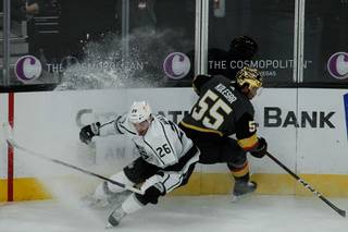 Kings defenseman Sean Walker (26) and Golden Knights right wing Keegan Kolesar (55) maneuver towards the puck in the third period of their game at T-Mobile Arena, Monday, March 29, 2021. The Golden Knights beat the Kings 4-1.