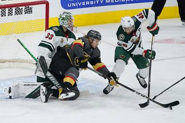 Minnesota Wild defenseman Jared Spurgeon (46) and Vegas Golden Knights center William Karlsson (71) vie for the puck during the first period of an NHL hockey game Thursday, April 1, 2021, in Las Vegas.