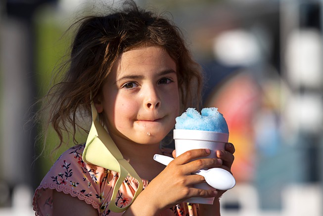 Aria Telford, 6, enjoys a cotton candy blue Snowie shaved ...