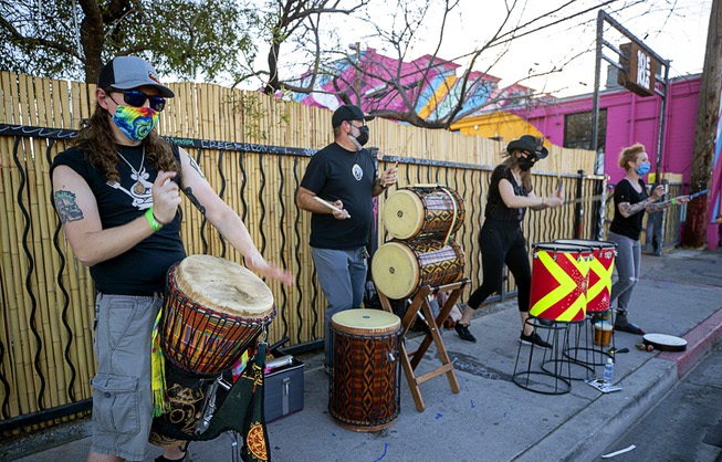 Drummers perform outside the Bin 19 restaurant during First Friday ...