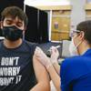 Duran Heath, 24, gets the COVID-19 vaccine at UNLV on April 5, 2021. Beginning Friday, Gov. Steve Sisolak is mandating that all people, regardless of vaccination status, wear masks in most public, indoor places in Clark County.