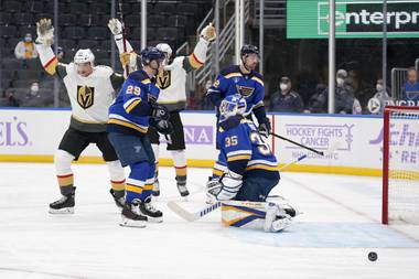 Vegas Golden Knights’ Tomas Nosek, left, celebrates after scoring past St. Louis Blues goaltender Ville Husso (35) and Vince Dunn (29) during the first period of an NHL hockey game Monday, April 5, 2021, in St. Louis. (AP Photo/Jeff Roberson)